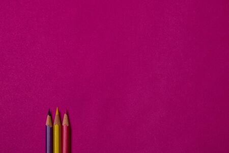 Multi colored crayons at magenta background with copy space.の写真素材