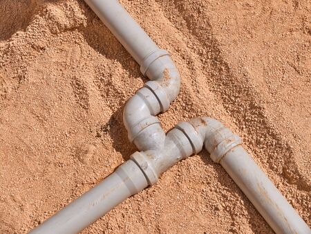 Junction of plastic sewer pipes. Sewage pipeline system of residential building under construction.の写真素材