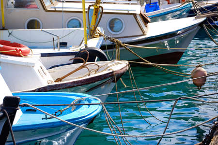 moored boats at marina in the sunny afternoon.
