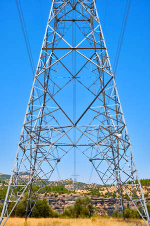 the high voltage power line is laid on a rocky terrain.