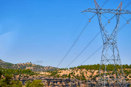 the high voltage power line is laid on a rocky terrain.