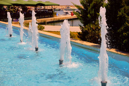 twinkling streams of water jets in fountain.