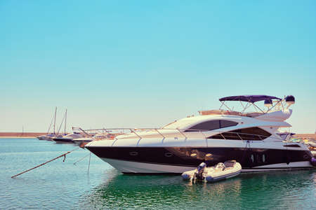 Yachts and boats moored at marina toned.の写真素材