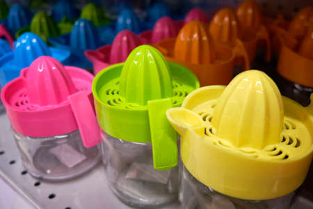 Multi colored plastic squeezers at market counter.の写真素材