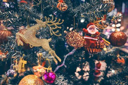 Santa Claus and reindeer baubles at Christmas tree. New year decorationsの写真素材