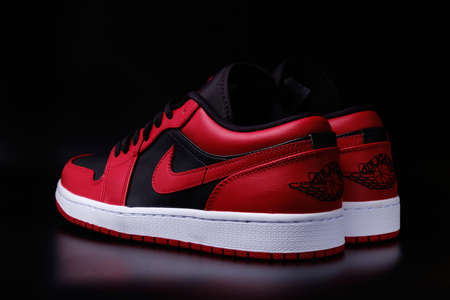 Nike Air Jordan 1 Retro Low Reverse Bred colorway sneakers on black background illustrative editorial.のeditorial素材