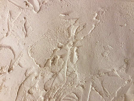 Textured plaster. Beige wall stucco texture. Plastered background.