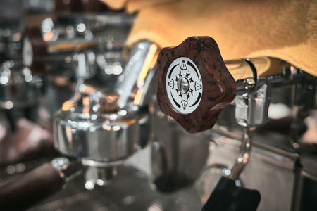 Close up of professional coffee machine. Brown handles and chrome surfaces of coffee machine