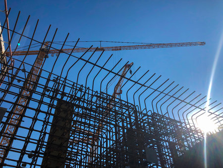 Tower cranes against blue sky. Lifting machinery at construction site.の写真素材