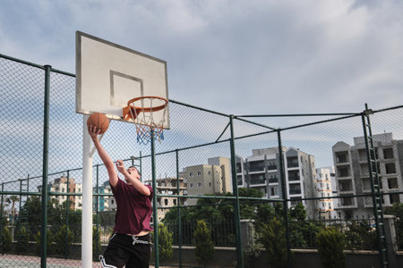 Man plays basketball at outdoor court