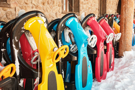 Row of colorful sleds for rent