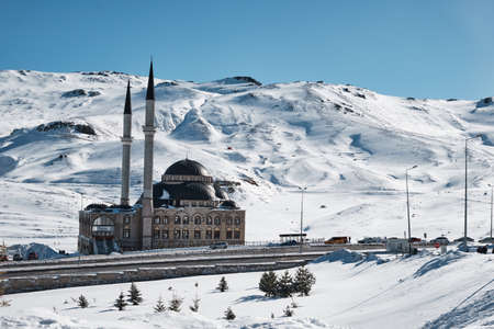 Mosque against snowy valley and blue skyの写真素材