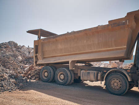 Dump truck unloads soil from truck backの写真素材
