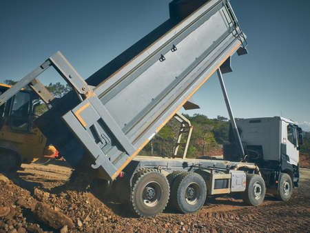 Dump truck unloads soil from truck back