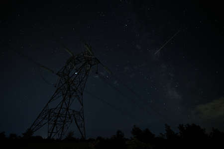 Power line pylon against summer starry nightの写真素材