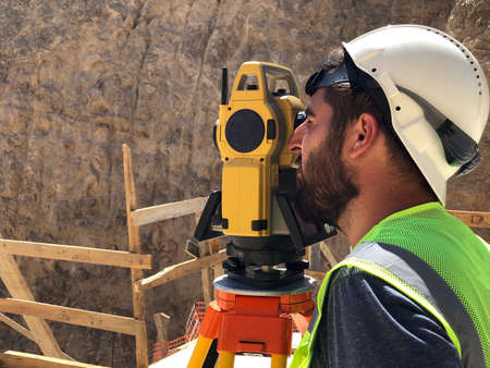 Land surveyor looks into a telescope of theodolite