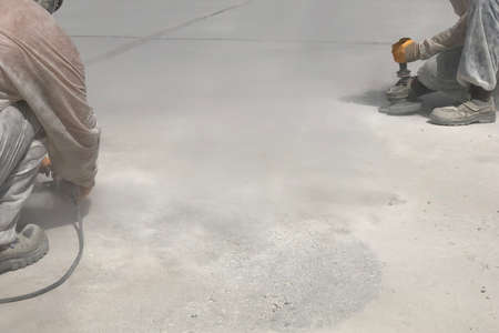 Construction workers are grinding concrete surface
