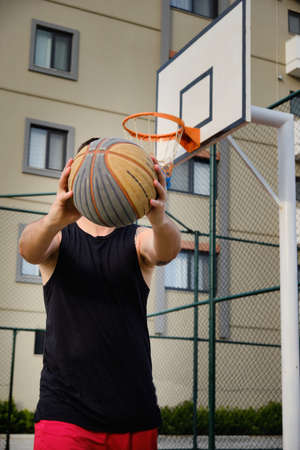 Man plays basketball at outdoor courtの写真素材