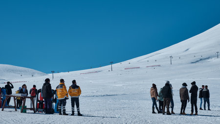 Mountain rescuers watch skiers on the hill slopeのeditorial素材