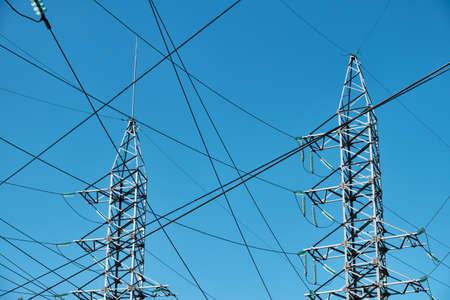 High-voltage power line against blue skyの写真素材