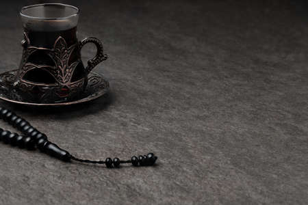 Glass of tea and rosary beads