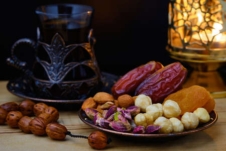 Dried fruits and tea lighten by lanternの写真素材