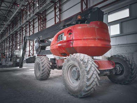 Boom lift picker inside industrial buildingの写真素材