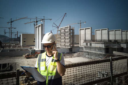 Site engineer calling on his mobile phone at construction site