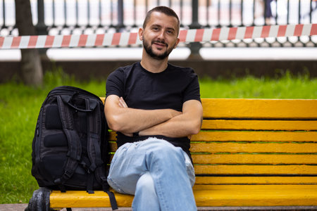Caucasian man sits on a benchの写真素材