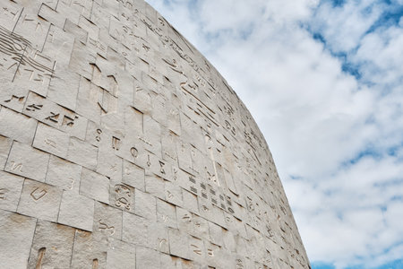 The Bibliotheca Alexandrina or Library of Alexandria is a major library and cultural center on the Mediterranean shore in Alexandria, Egypt. Ancient Egyptian hieroglyphs on the facade against skyの写真素材