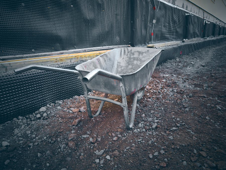 Metal wheelbarrow at construction site.の写真素材