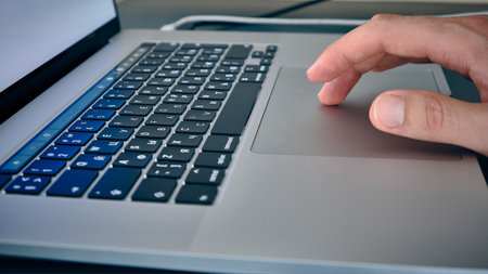 Hand on laptop touchpad