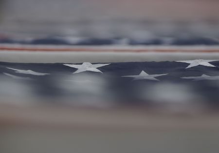 Flag draped casket forms an abstract, patriotic background.の写真素材