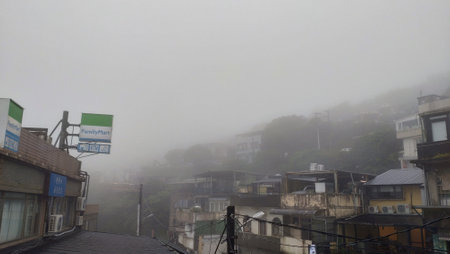 The fog and cloud around the village on the rainy day in Jiufen in New Taipei City in Taiwanの写真素材
