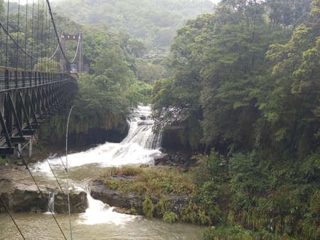 The waterfall with rich water after rainingの写真素材
