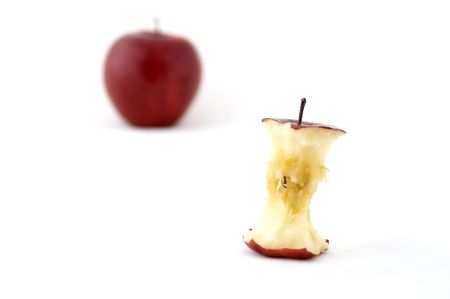An apple core with an out of focus apple in the backgroundの写真素材