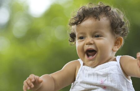 happy toddler in a tropical garden