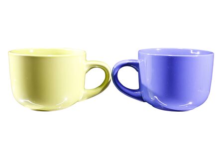 colored teacups, isolated on white backgroundの写真素材