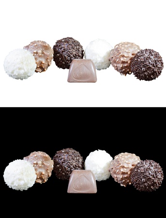 set of luxury chocolates in white, black and milk chocolate, isolated on white and black backgroundの写真素材