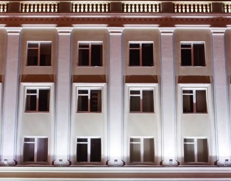 facade of an office building at night facade of an office building at night