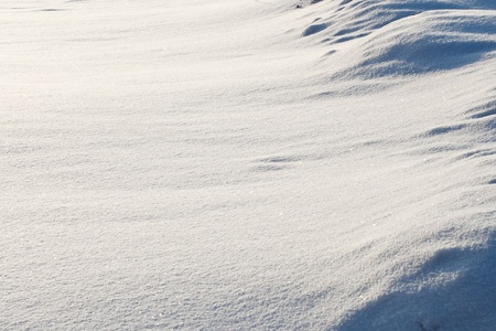 abstract background of snow-drifts of snow on the sunの写真素材