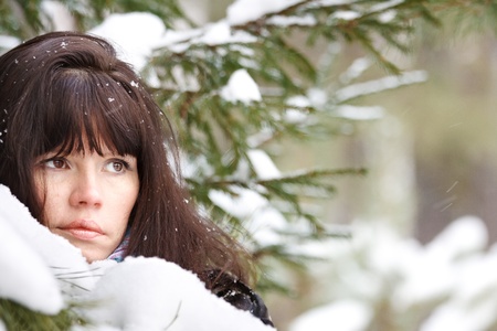closeup portrait of a young girl on the background of the winter forestの写真素材