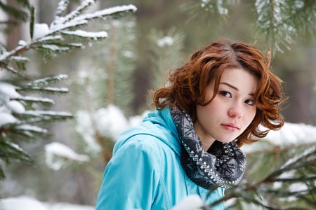 portrait of a young girl on a background of a winter forestの写真素材