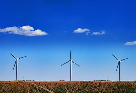 Wind turbines in country in front of nice cloudsの写真素材