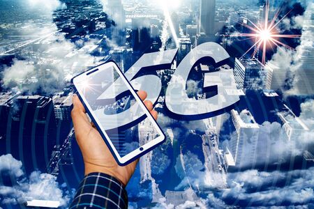 Digitally created 5G image with clouds and overhead view of St. Louis MO holding digitally created phoneの写真素材