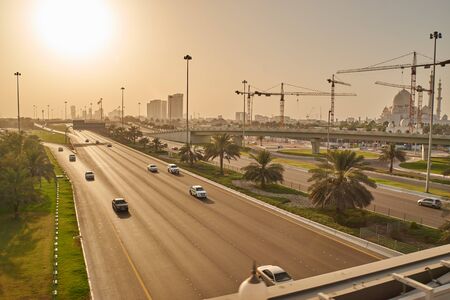 afternoon sun shining on Abu Dhabi street with grand mosque in backの写真素材