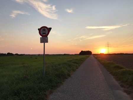 sunset with blue and red sky at a country lane in Germanyの写真素材