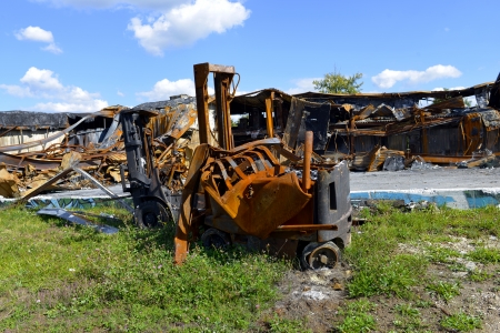 vehicle burned in front of a warehouseの写真素材