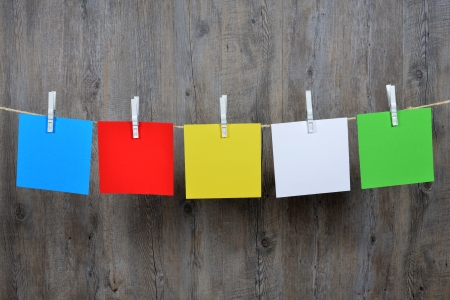 5 colored post it hanging on a clotheslineの写真素材