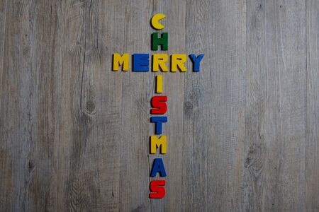 merry christmas written with small letters painted woodの写真素材